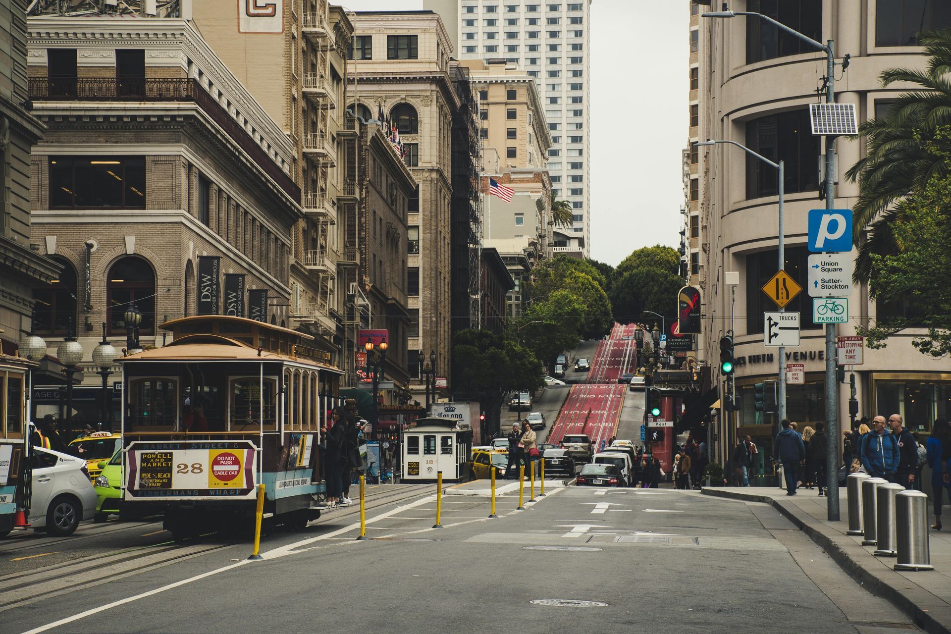 A trolley is driving down a city street.