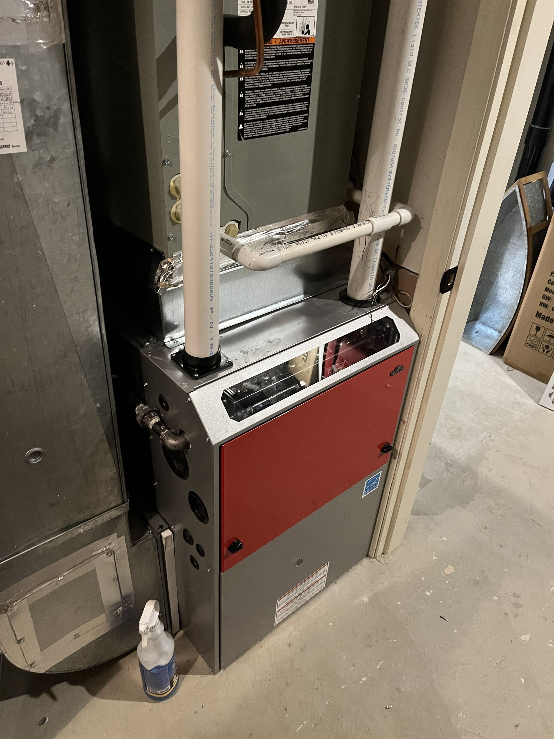 Industrial electrical panel with red cover and pipes in a utility room