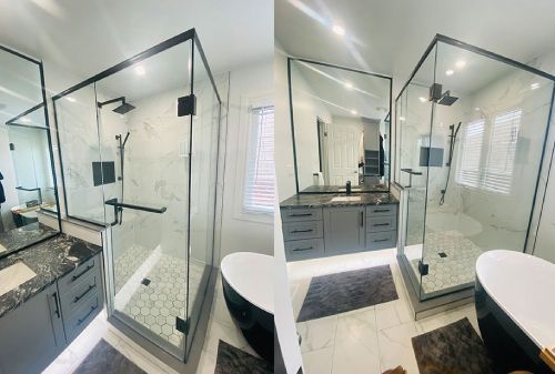 Modern bathroom with dual glass showers, double vanity, and white tile flooring