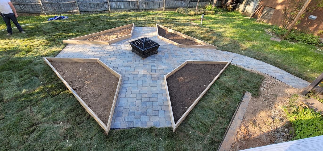 A brick walkway in a backyard
