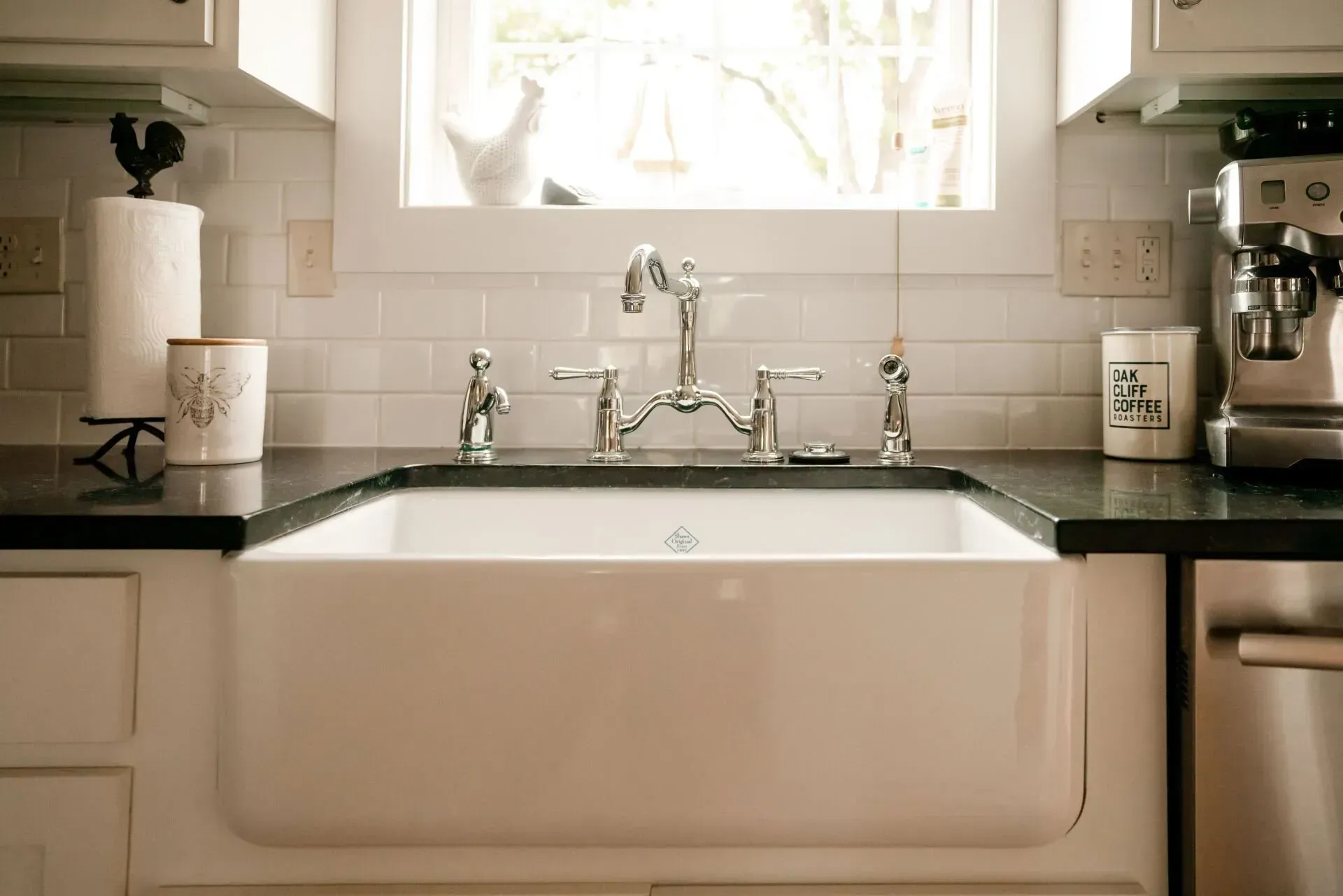 A kitchen sink is sitting on a counter next to a window
