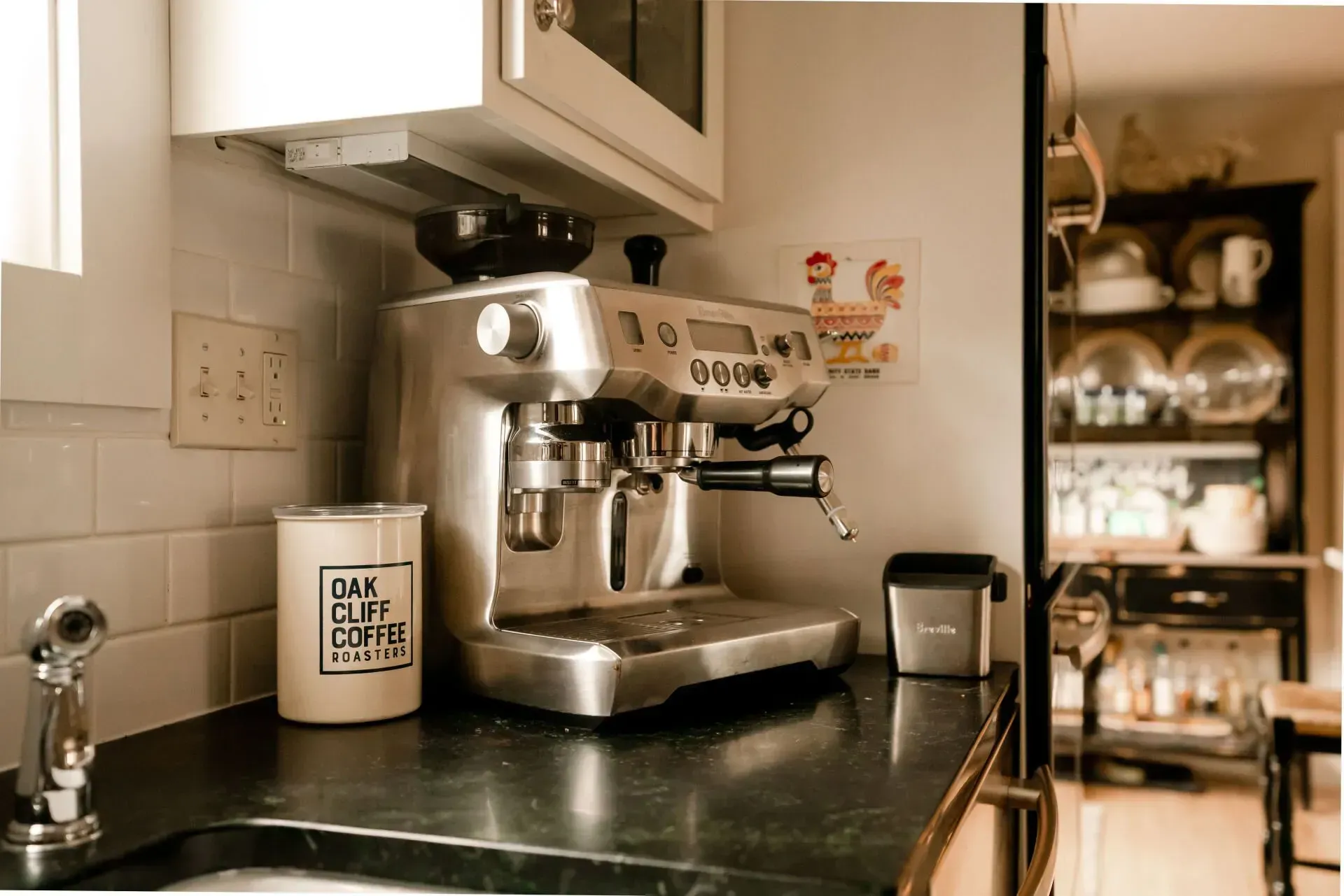 A coffee machine is sitting on a kitchen counter next to a sink