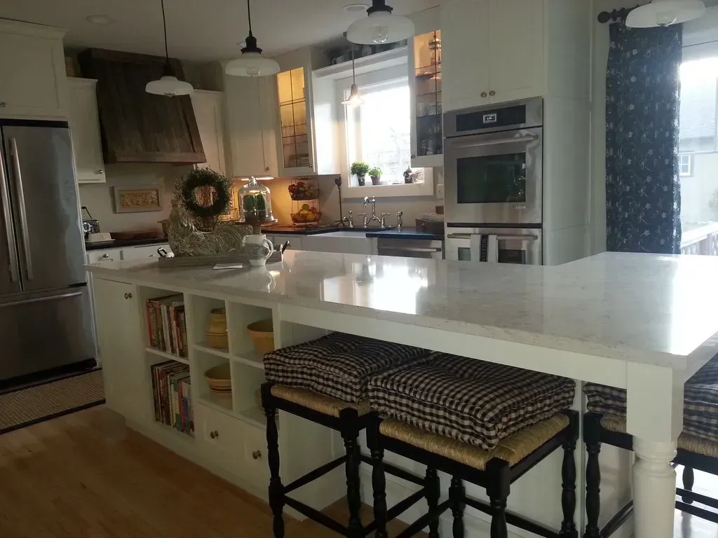 A kitchen with a large island and stools