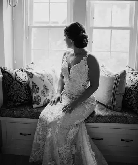 A black and white photo of a bride in a wedding dress