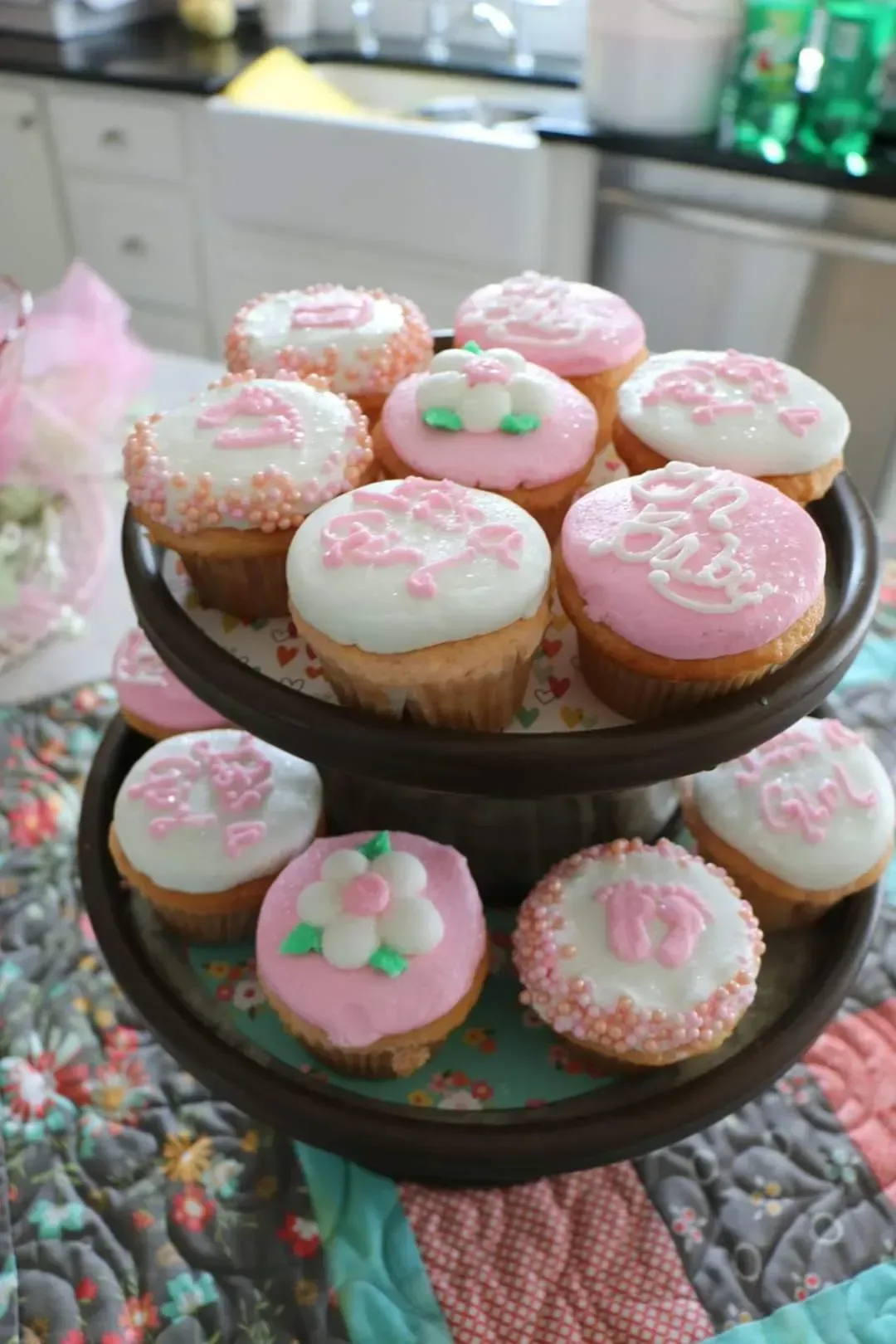 A tray of pink and white cupcakes