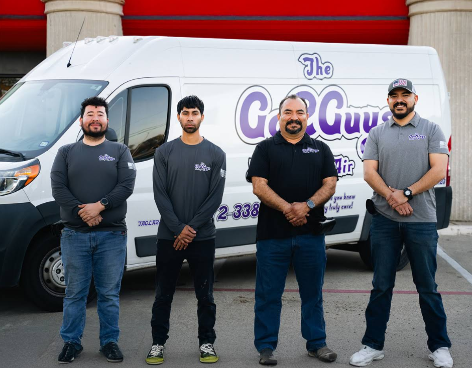 Four people standing in front of a white service van with “The Geo Guy” logo.