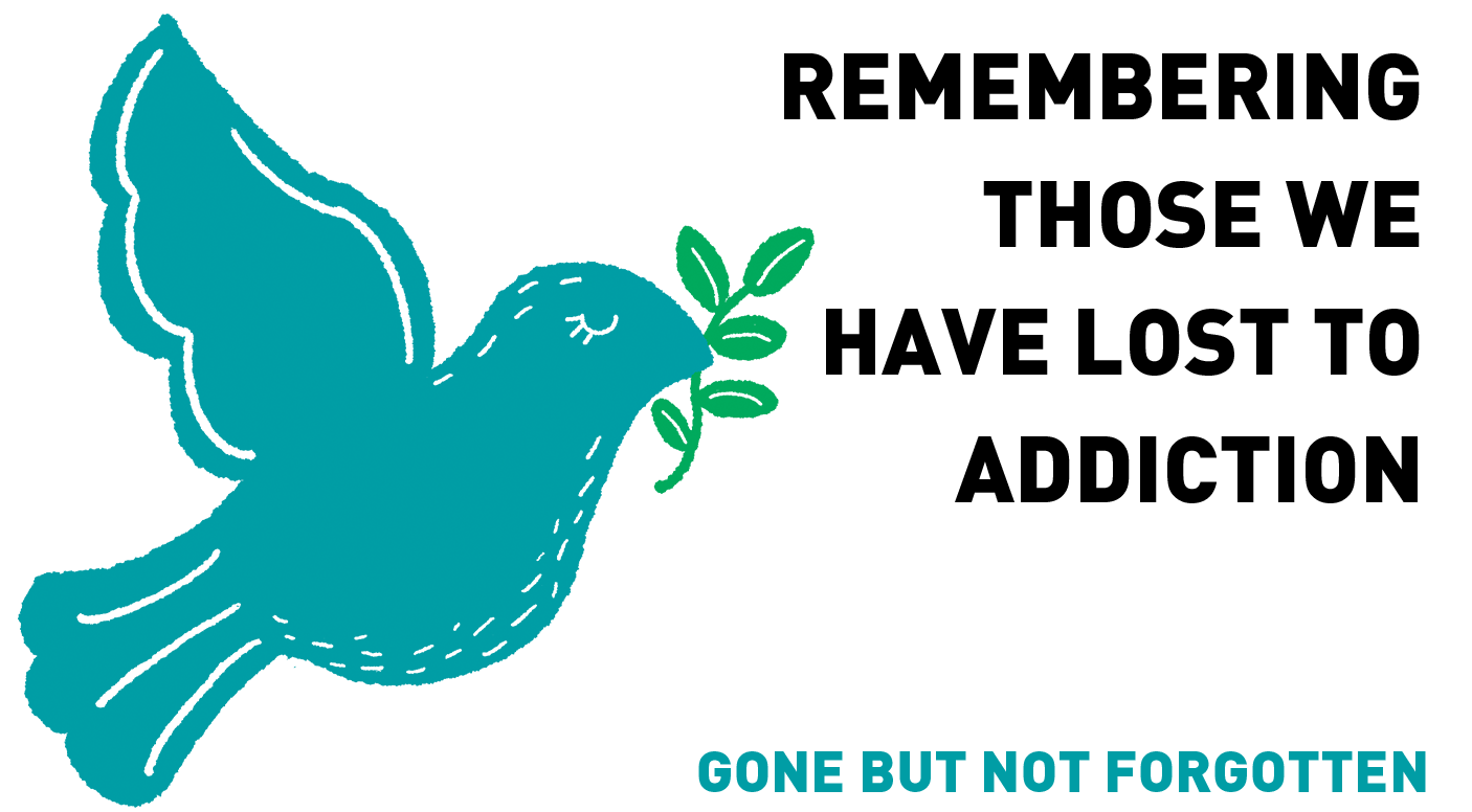 A blue dove is flying with a branch in its beak.