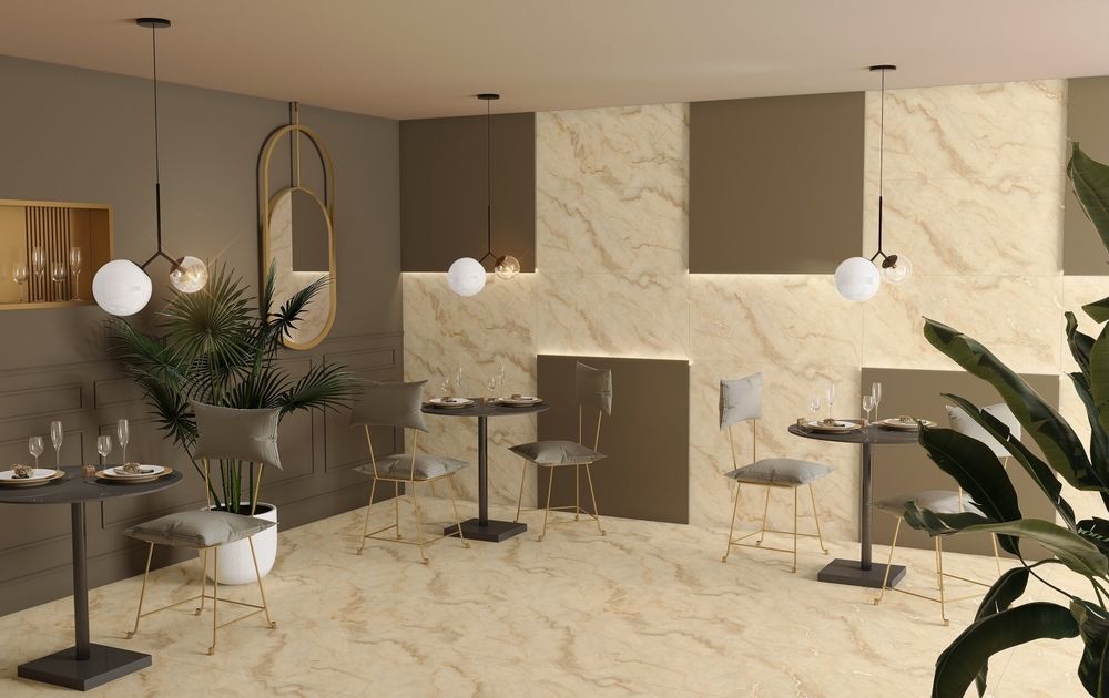 Modern restaurant interior with round tables, chairs, globe pendant lights, and decorative plants.
