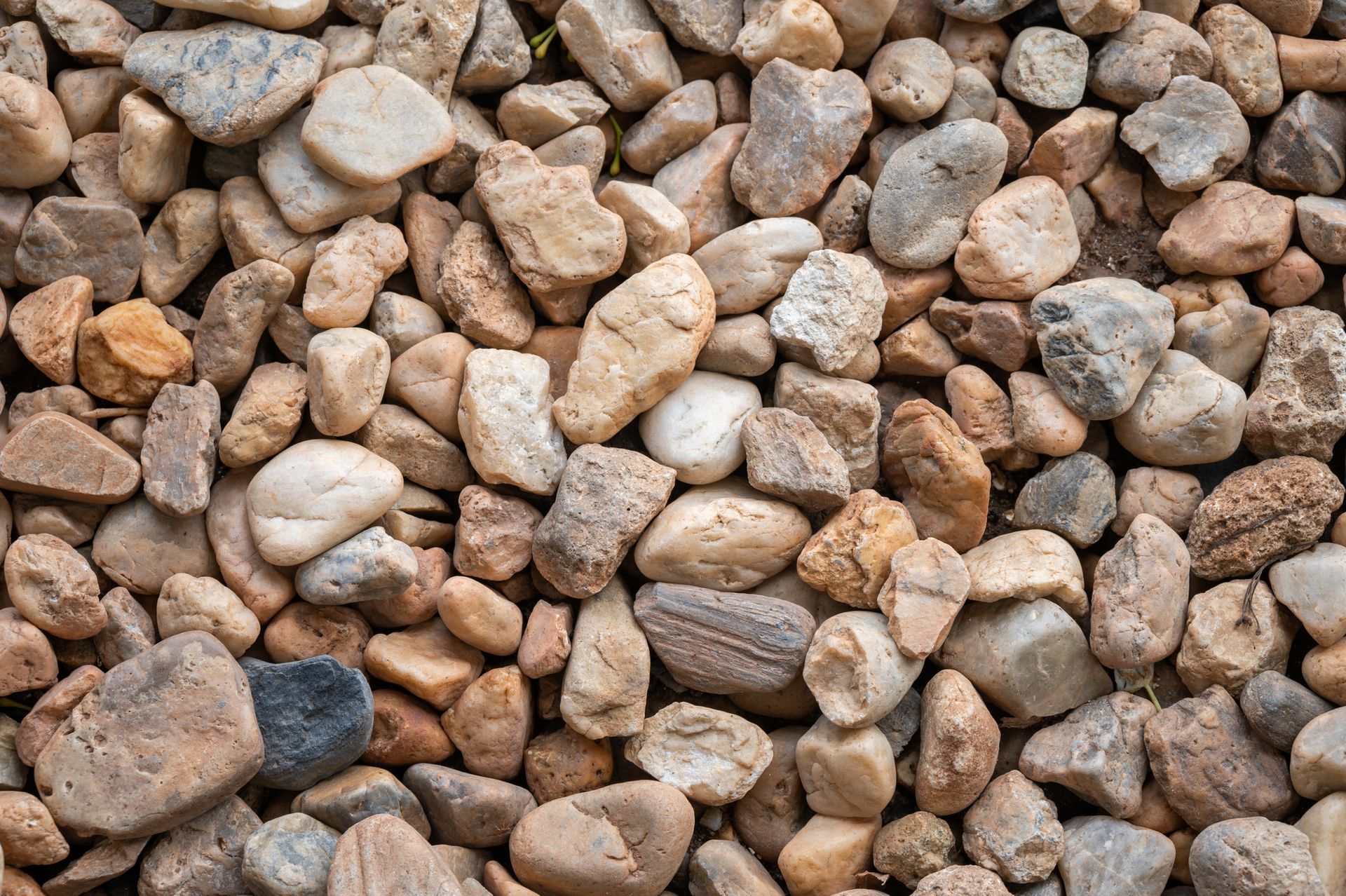 A pile of rocks sitting on top of each other on the ground.