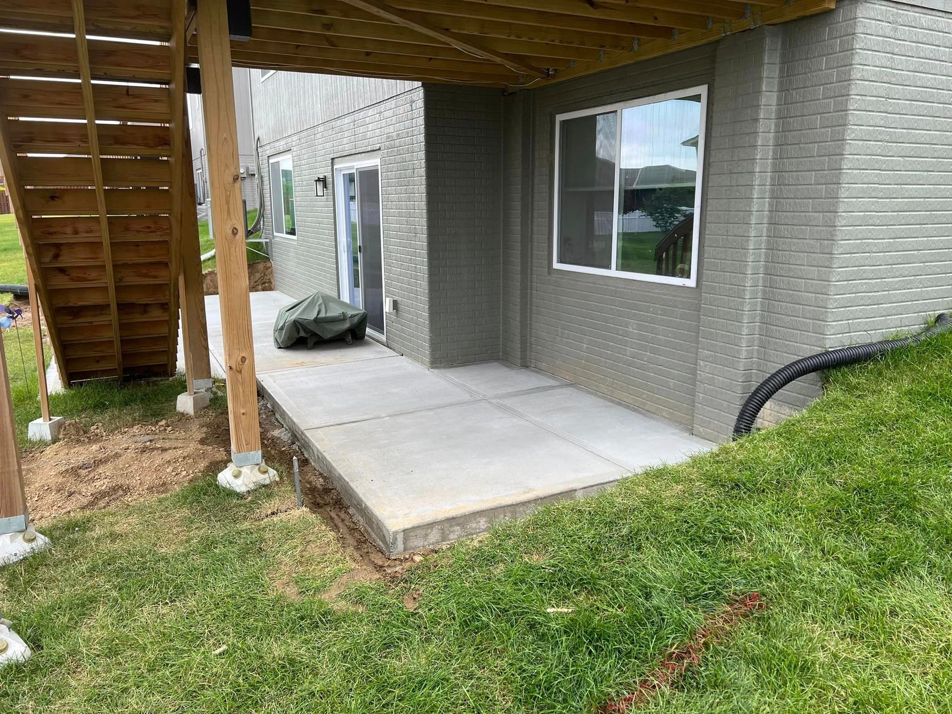 A house with a patio and stairs in the backyard.