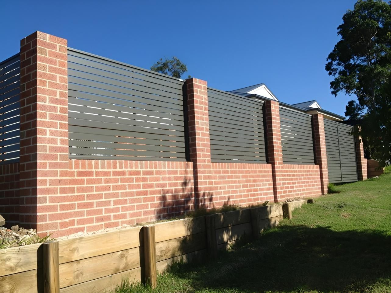 A Brick Wall With a Metal Fence Surrounding It — Hunter Valley Lattice in Port Stephens, NSW