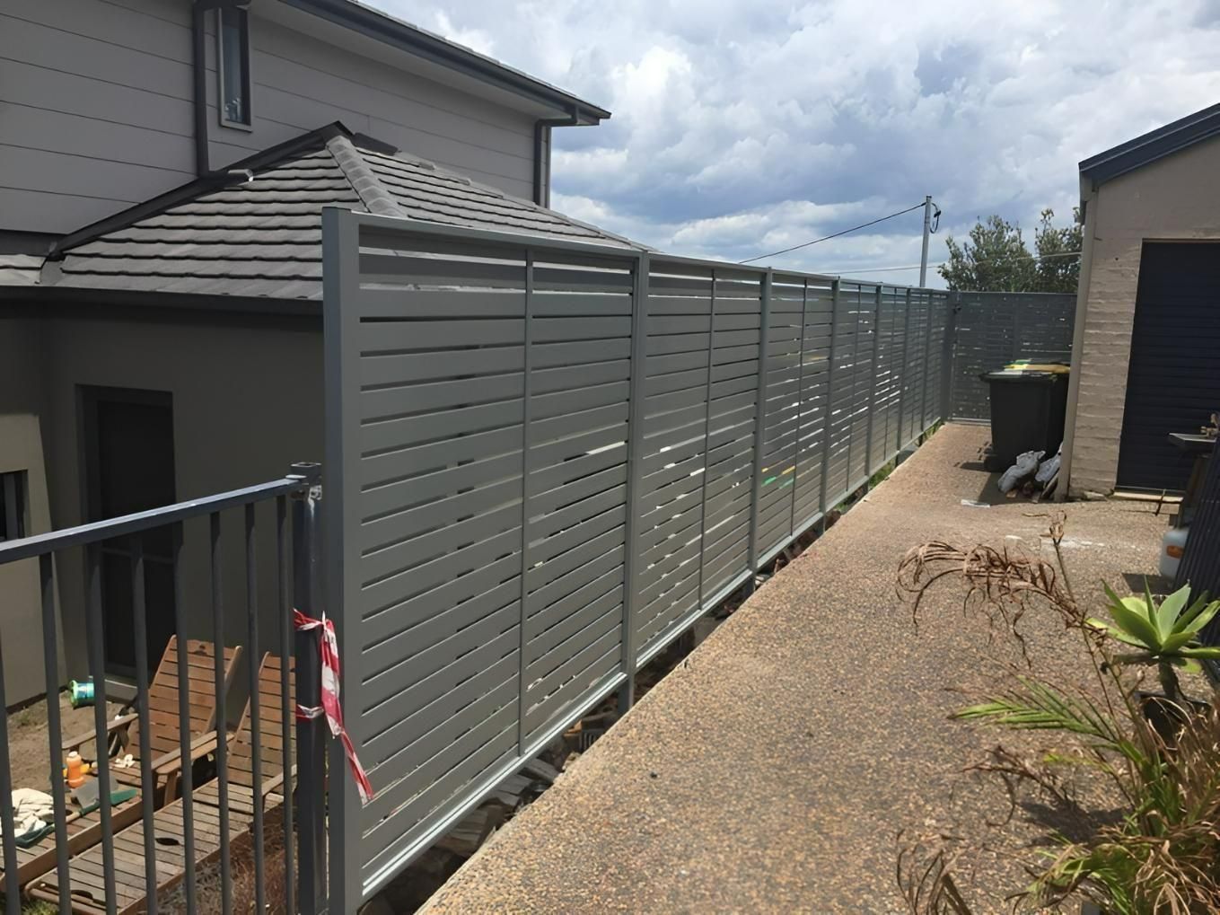 A Fence is Surrounding a Sidewalk in Front of a House — Hunter Valley Lattice in Lake Macquarie, NSW