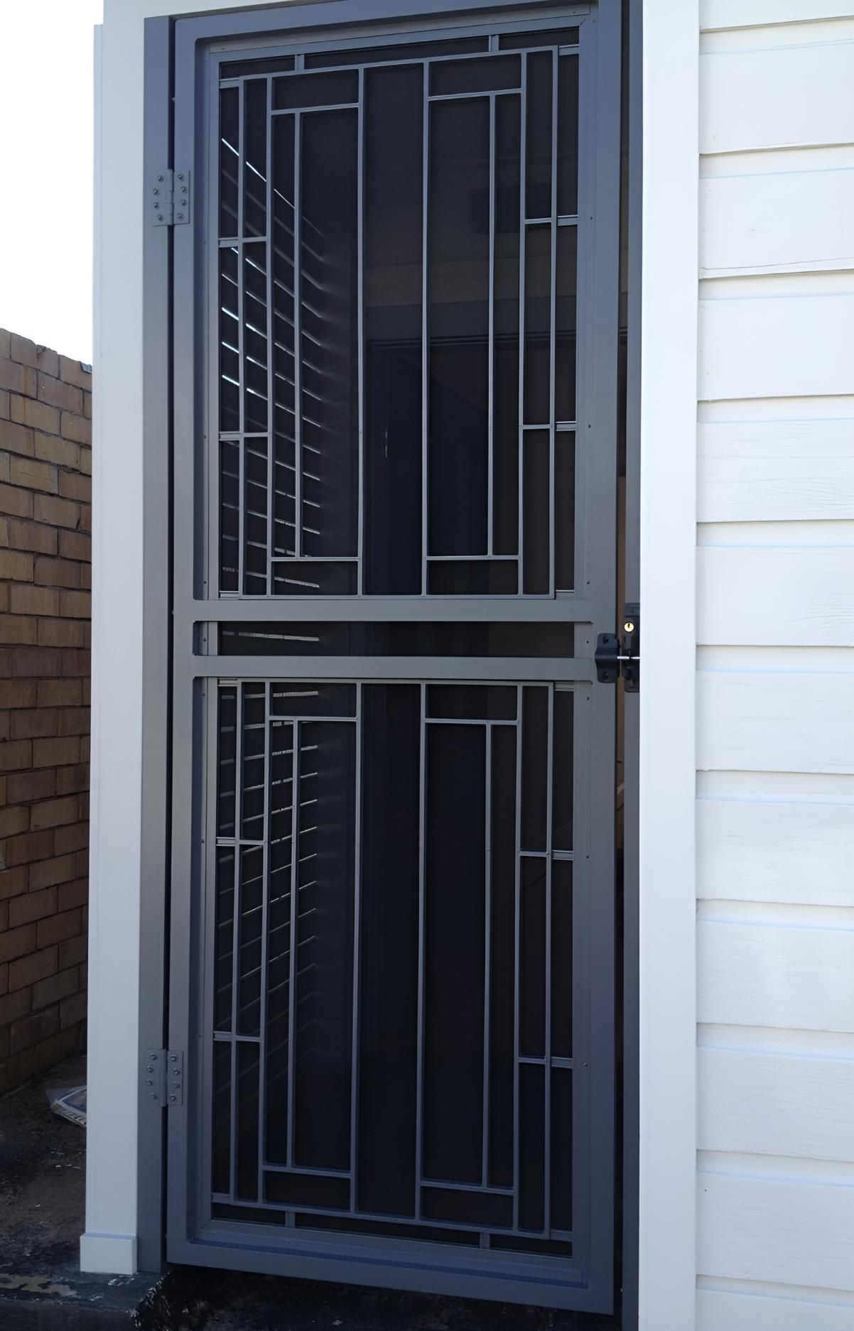 A Metal Gate With a Brick Wall in the Background — Hunter Valley Lattice in Cessnock, NSW