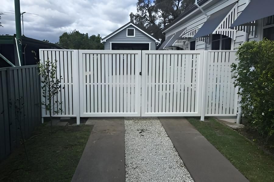 A White Fence Surrounds a Driveway Leading to a House — Hunter Valley Lattice in Port Stephens, NSW