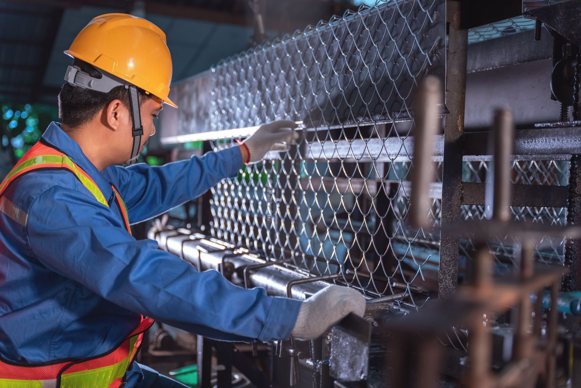 A technician is working on a production machine for steel wire mesh for construction work. A technician is working on a production machine for steel wire mesh for construction work.