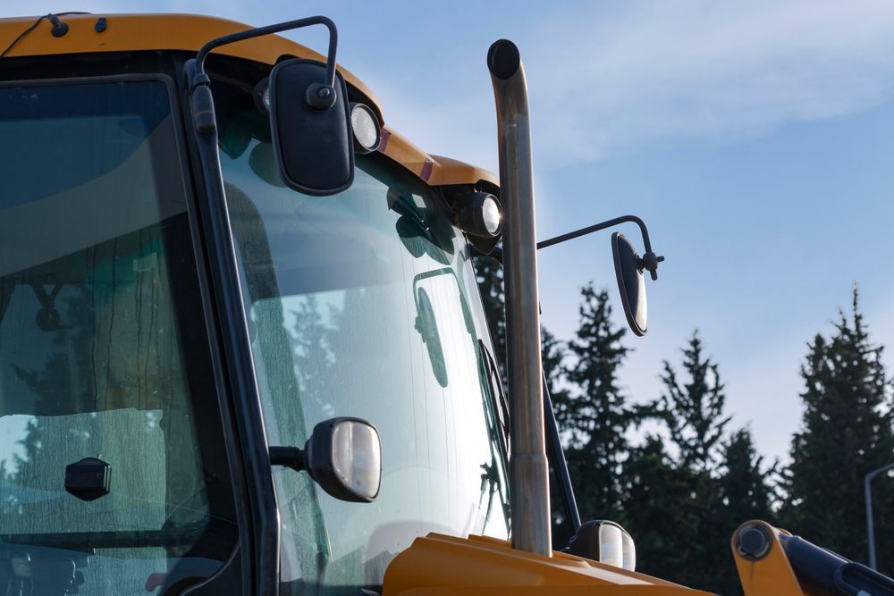 A Tow Truck Is Driving Down A Highway — Raymond Terrace Windscreen Services In Newcastle, NSW