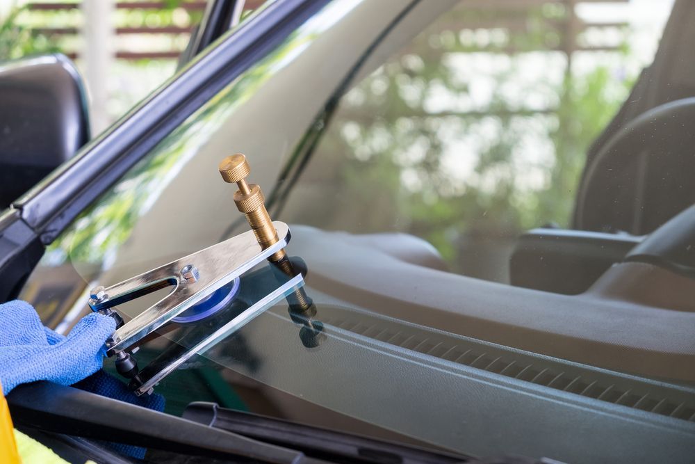 A Person Is Repairing A Windshield On A Car — Raymond Terrace Windscreen Services In Raymond Terrace, NSW