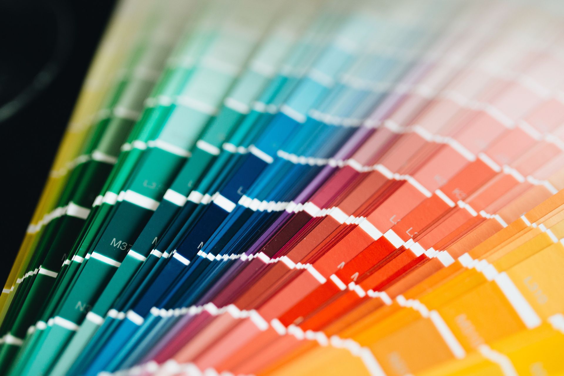 Stacked color swatches in a rainbow gradient, from green and blue to red, orange, and yellow.