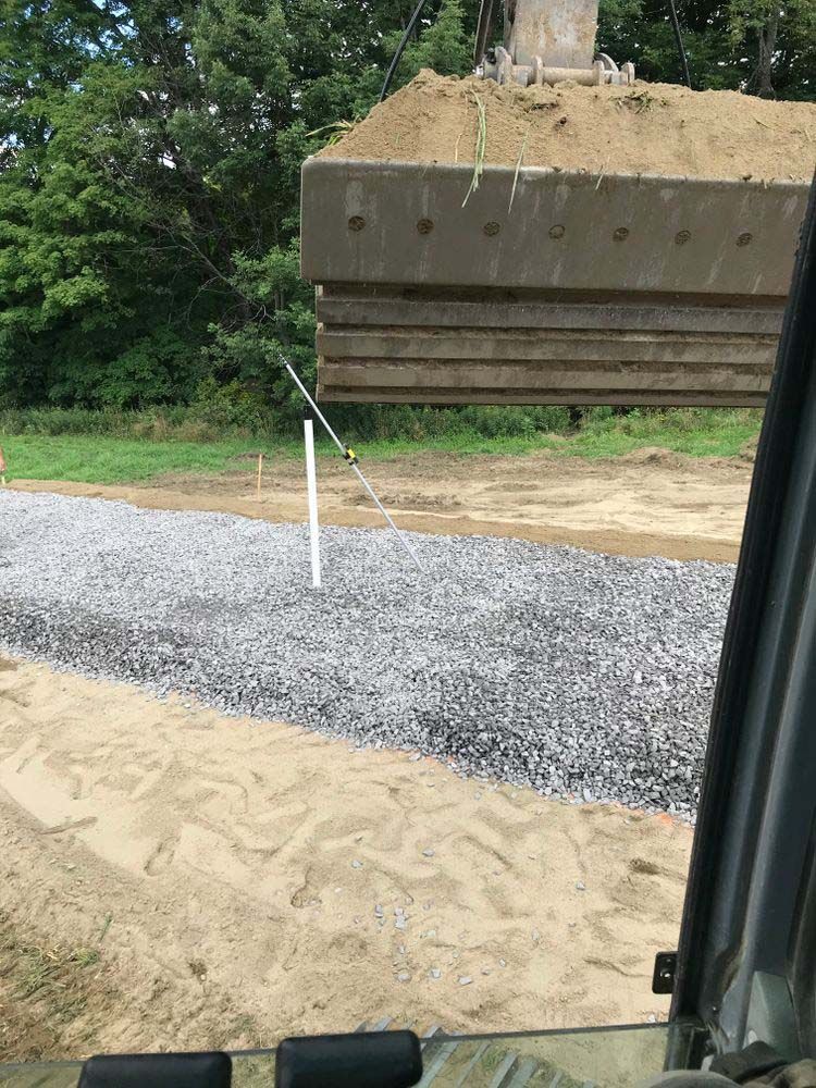 A large pile of dirt is being lifted by a bulldozer.