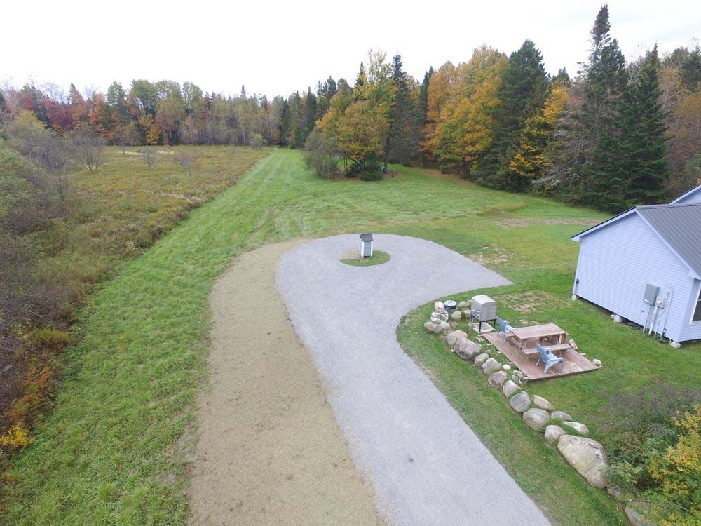 An aerial view of a driveway leading to a house
