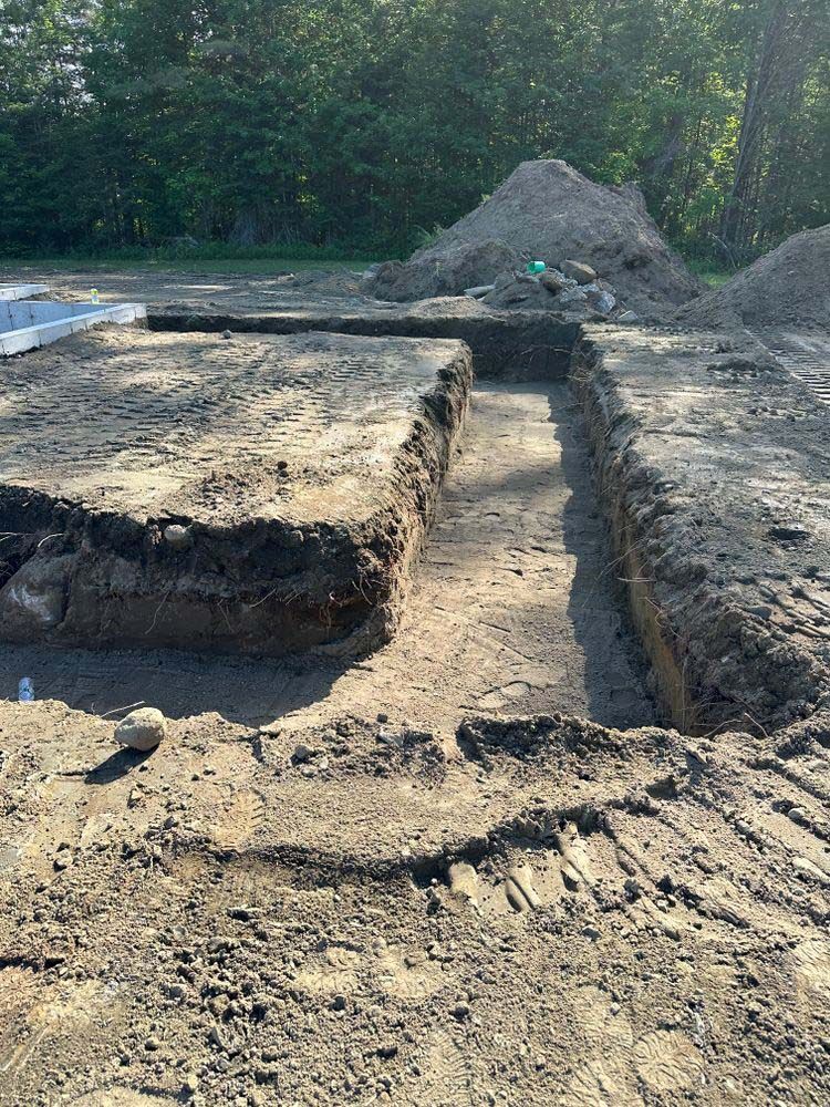 A large pile of dirt is sitting on top of a dirt field.
