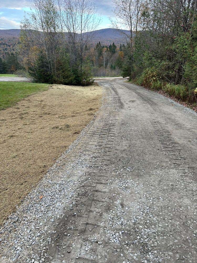 A dirt road with a lot of tire tracks on it.
