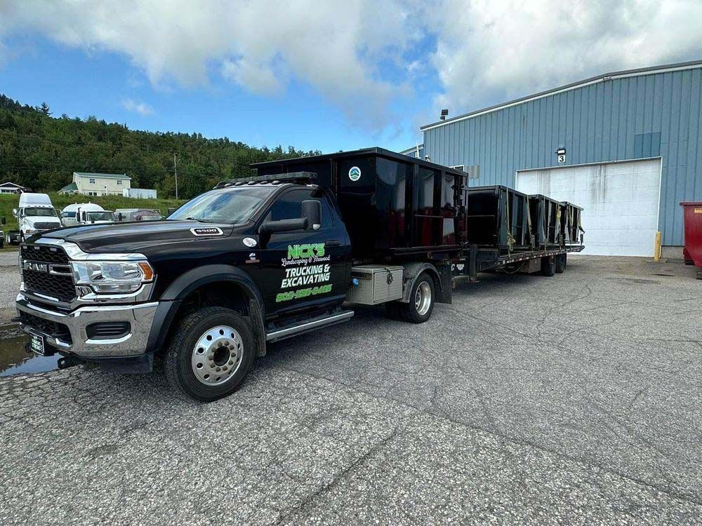 A dump truck is parked in front of a building.