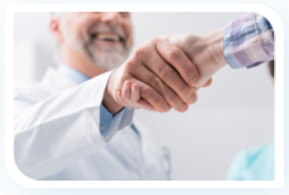 A doctor shaking hands with a patient in a hospital
