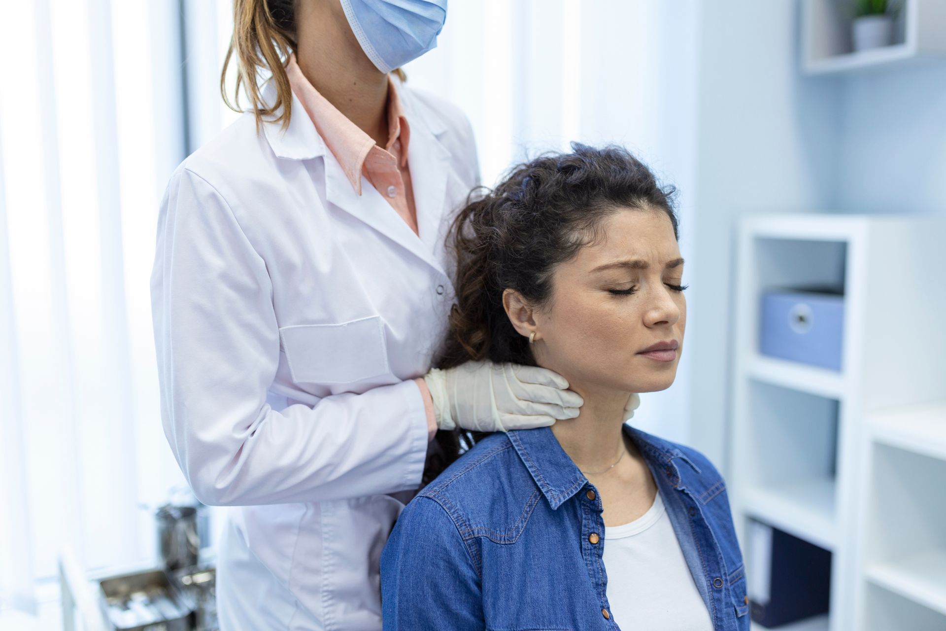 doctor examining the throat of a woman