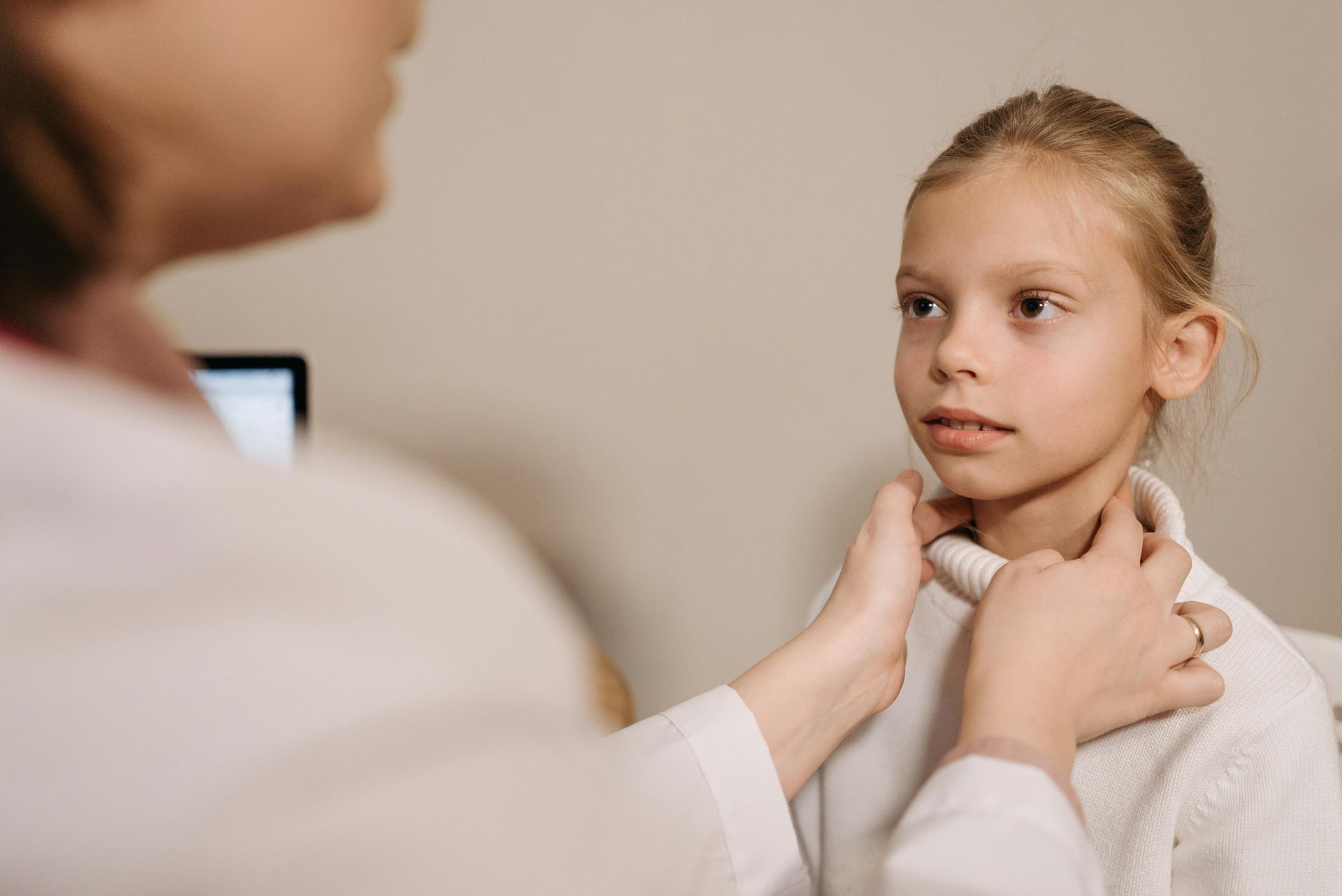 thyroid specialist examining a patient