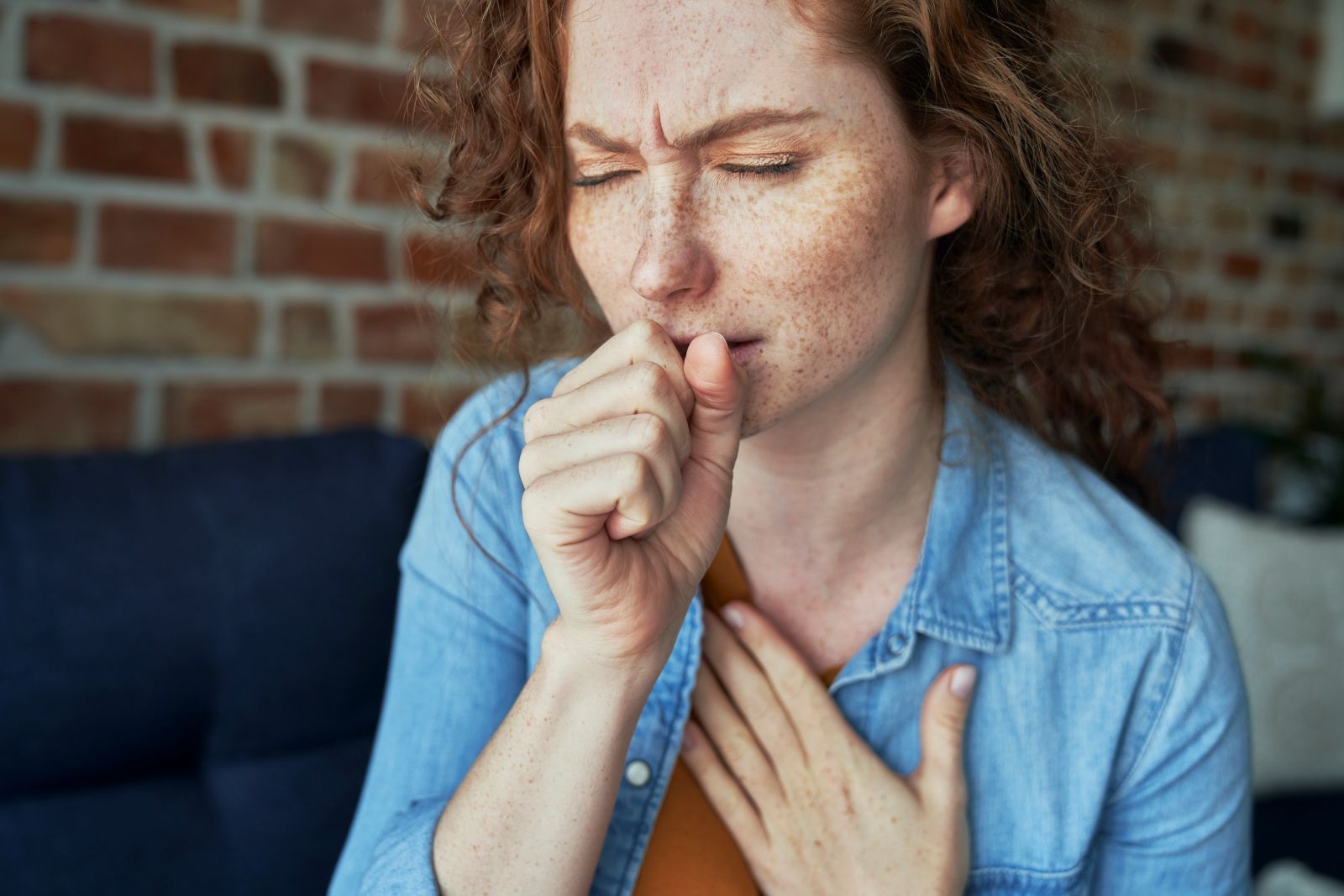 red-head-woman-coughing-to-clear-her-throat