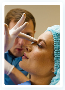 A woman is getting her nose examined by a doctor