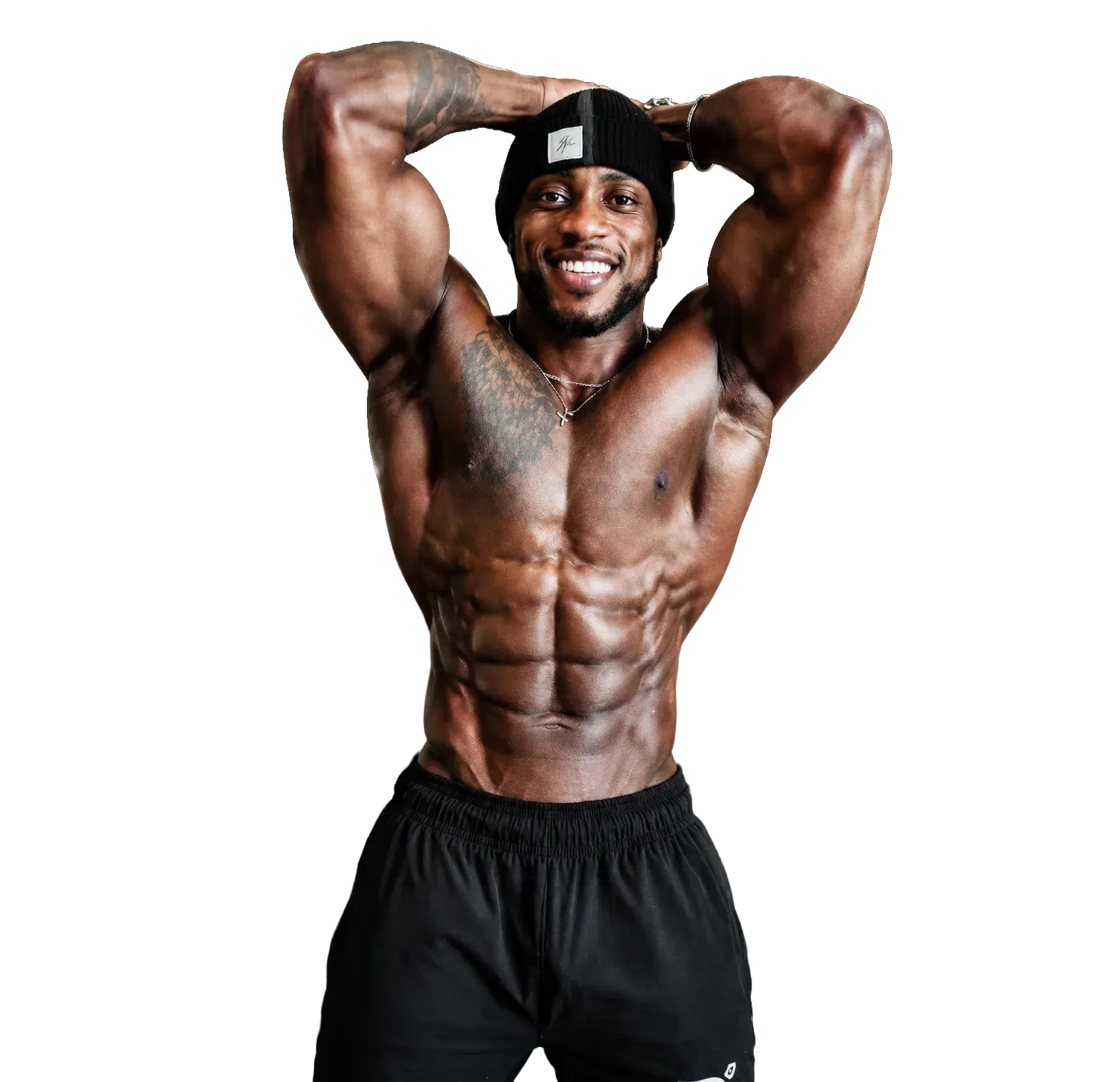 Muscular man posing with hands behind head, smiling, shirtless in black pants against a white background
