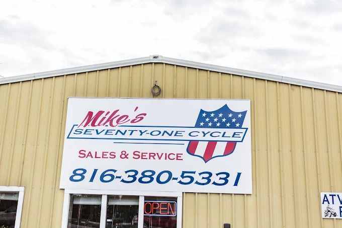 Storefront sign for Mike’s Seventy One Cycle Sales & Service with phone number 816-380-5331