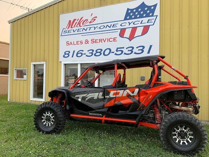Red and black Can-Am UTV parked outside Mike's Inventory Cycle sales and service shop