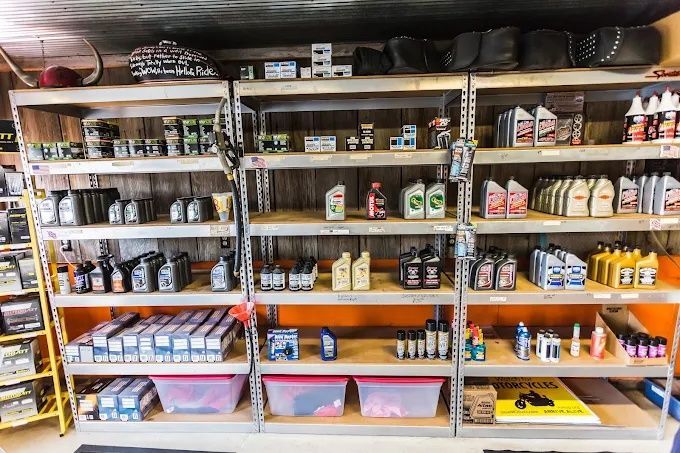 Shelves stocked with assorted jars, cans, and bottles in a small shop or pantry