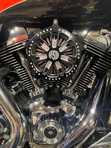 Chrome motorcycle engine with black detailing and a custom central air filter cover
