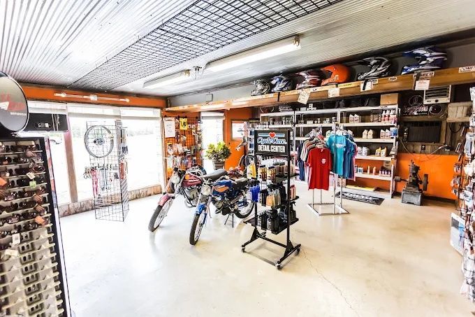 Bike shop interior with bicycles, shelves, and clothing displays under bright lighting