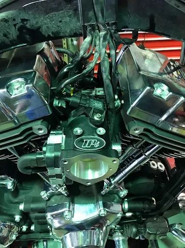 Close-up of a polished chrome car engine with hoses and wiring under the hood