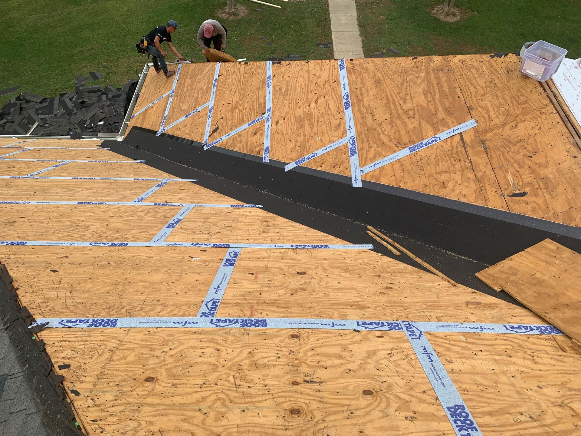 A man is working on the roof of a house.