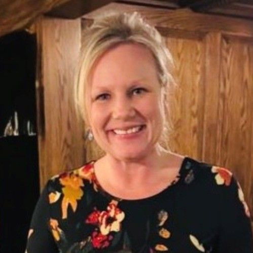A blonde woman smiles