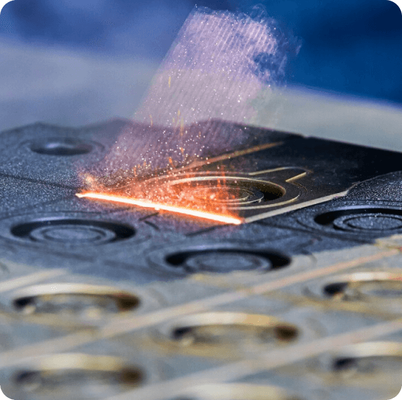 A close up of a piece of metal being cut with a laser.