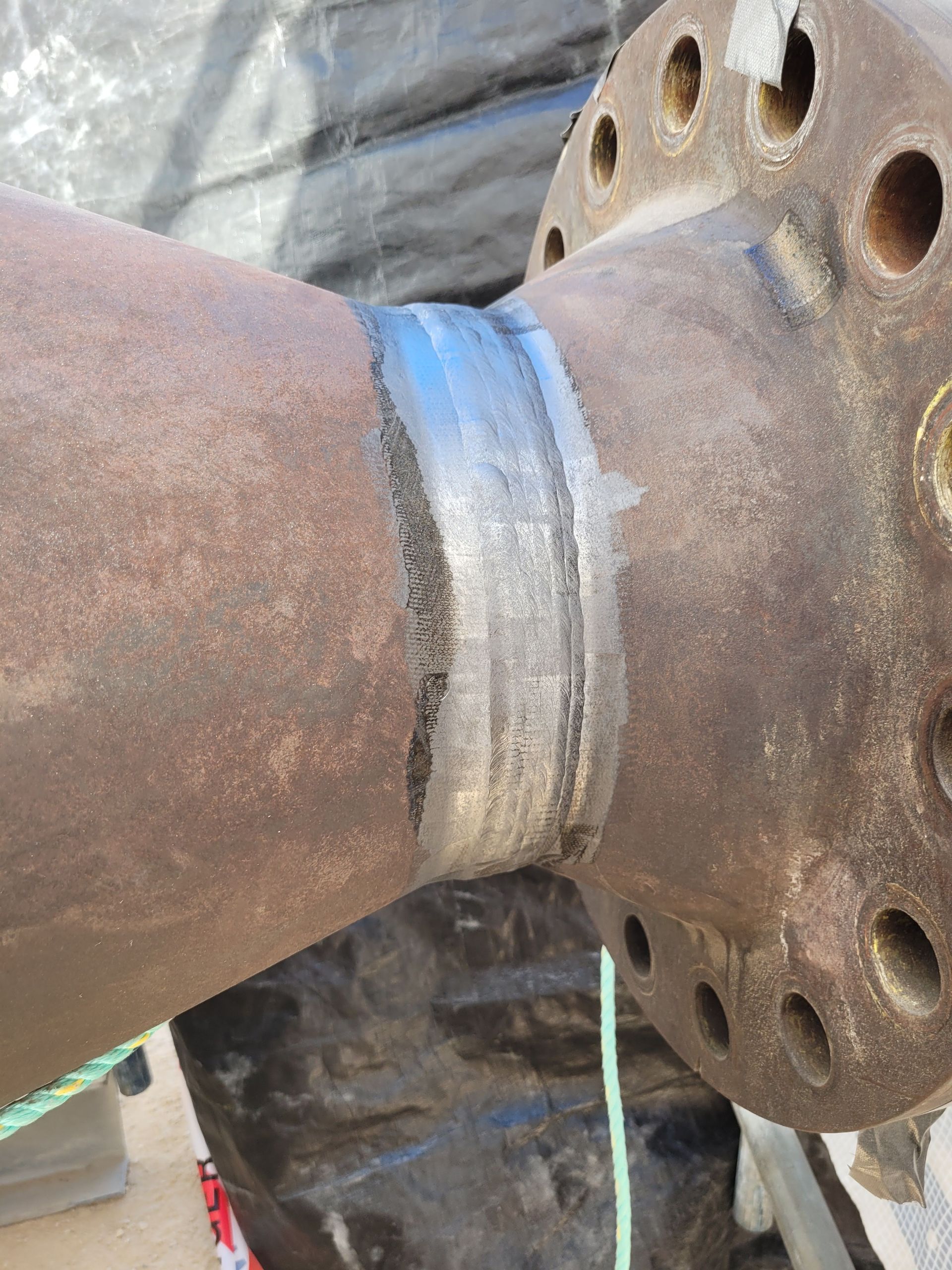 A close up of a rusty pipe with holes in it