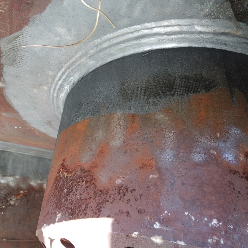 A close up of a rusty metal object with a white border