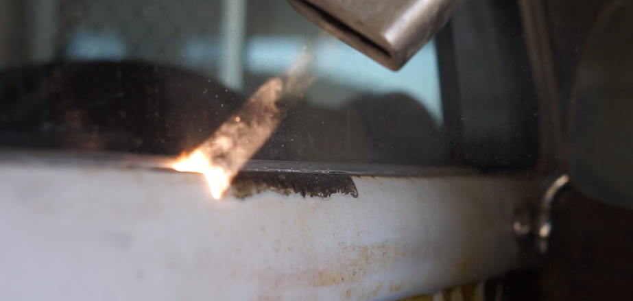 A close up of a fire coming out of a window.