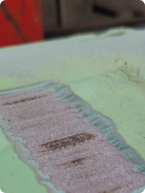 A close up of a green surface with a few spots on it