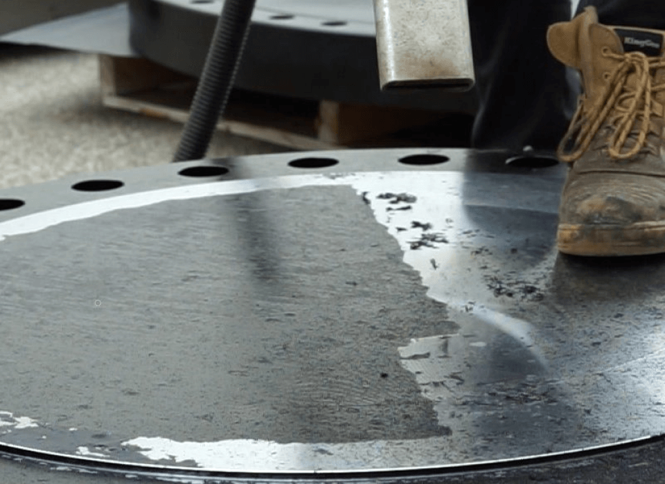 A person standing on a metal surface with holes in it