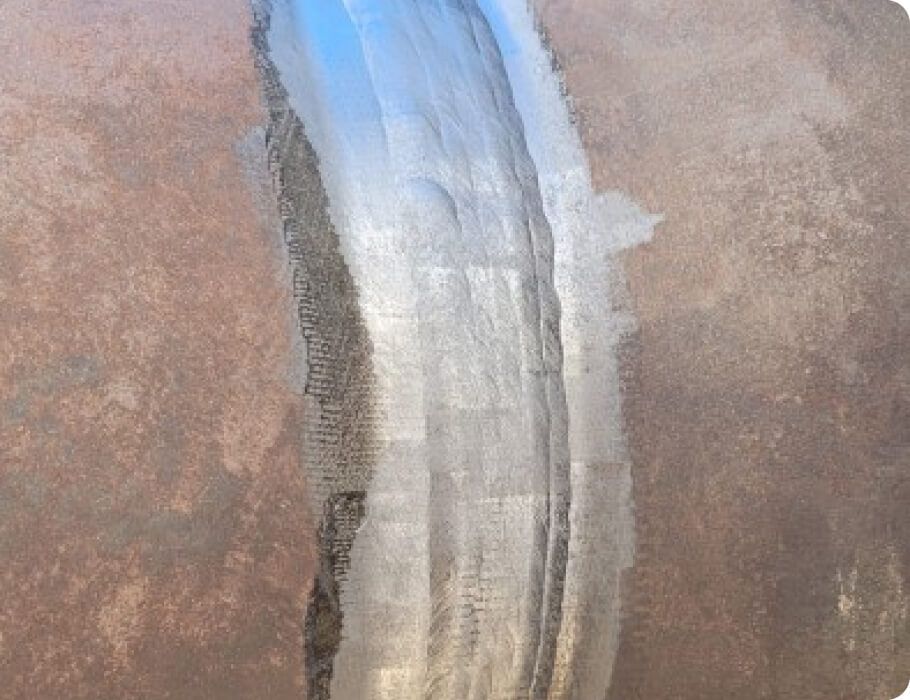 A close up of a piece of metal with a blue stripe on it.