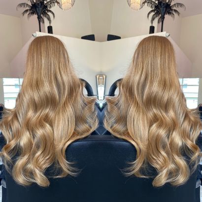 A reflection of a woman 's hair in a mirror
