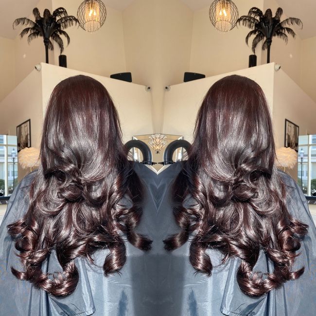A reflection of a woman 's hair in a mirror
